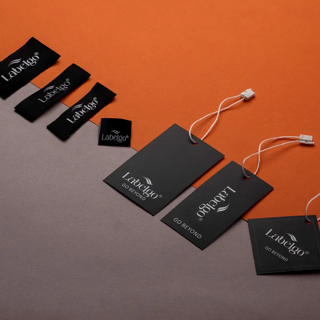 Custom Clothing Labels 21 Black textile hang tag labels with strings displayed on surface.