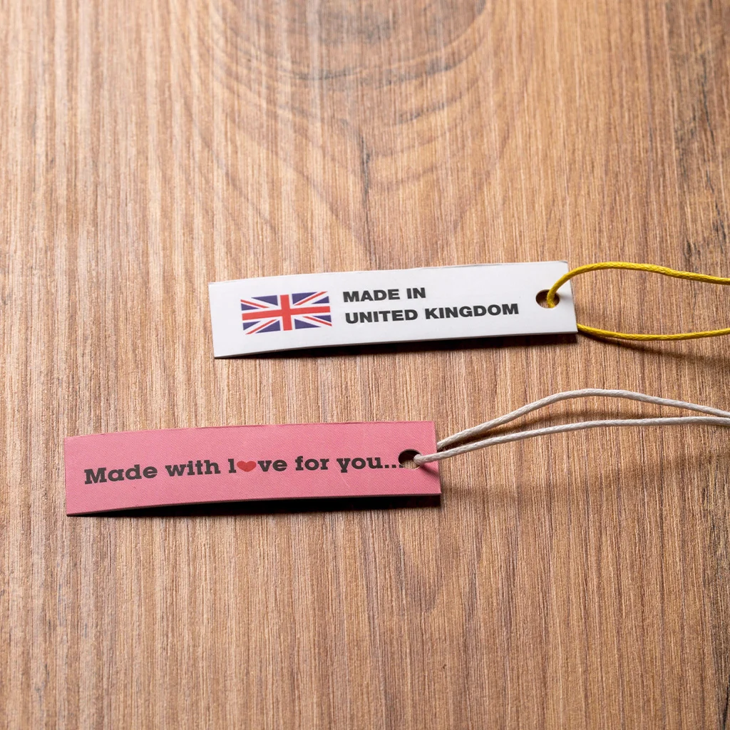 Slim Cardboard Garment Tags on Wood manufactured by LabelGo